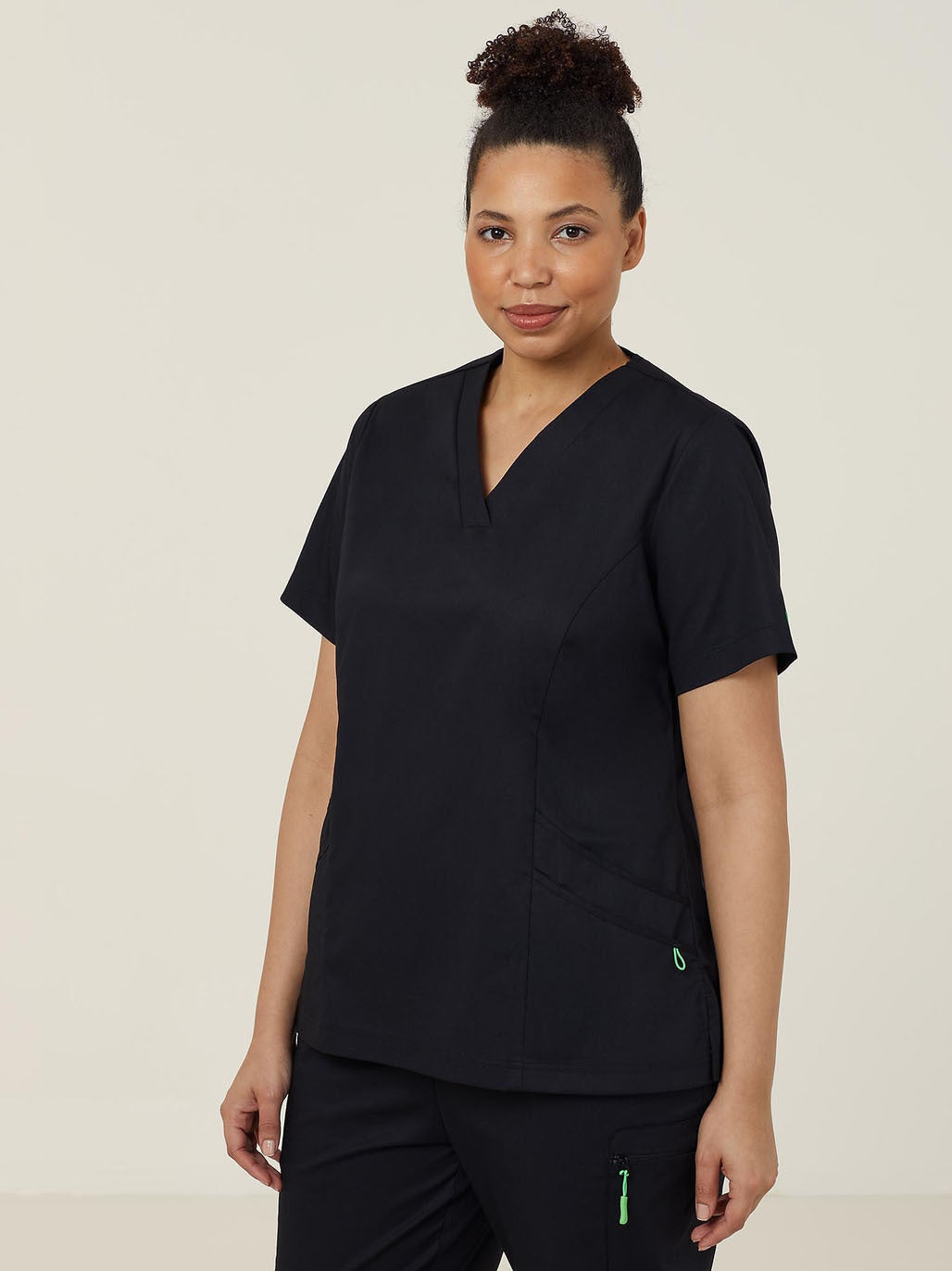 Woman wearing black scrubs.