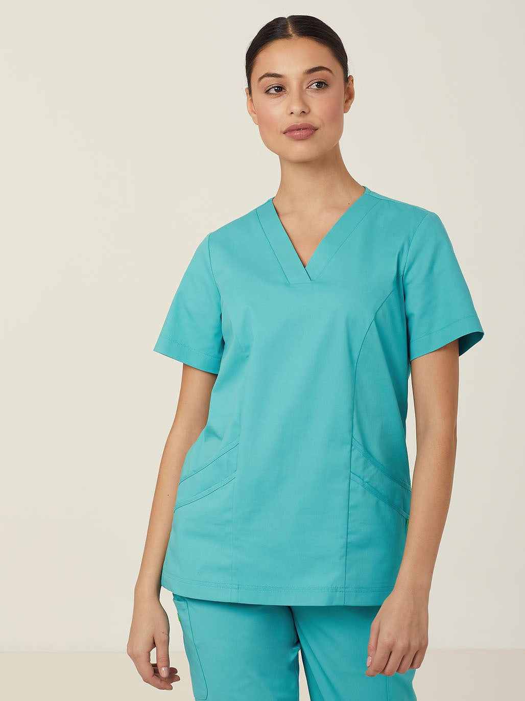 Woman wearing blue scrubs.